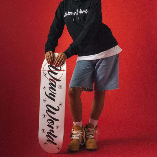 Wavy World Skateboard Deck from Drop 1 – Hip Hop & Cereal, shot leaning against our model—built to ride, styled to flex.