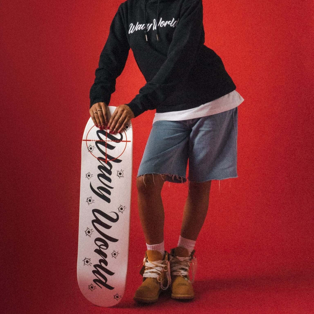 Wavy World Skateboard Deck from Drop 1 – Hip Hop & Cereal, shot leaning against our model—built to ride, styled to flex.
