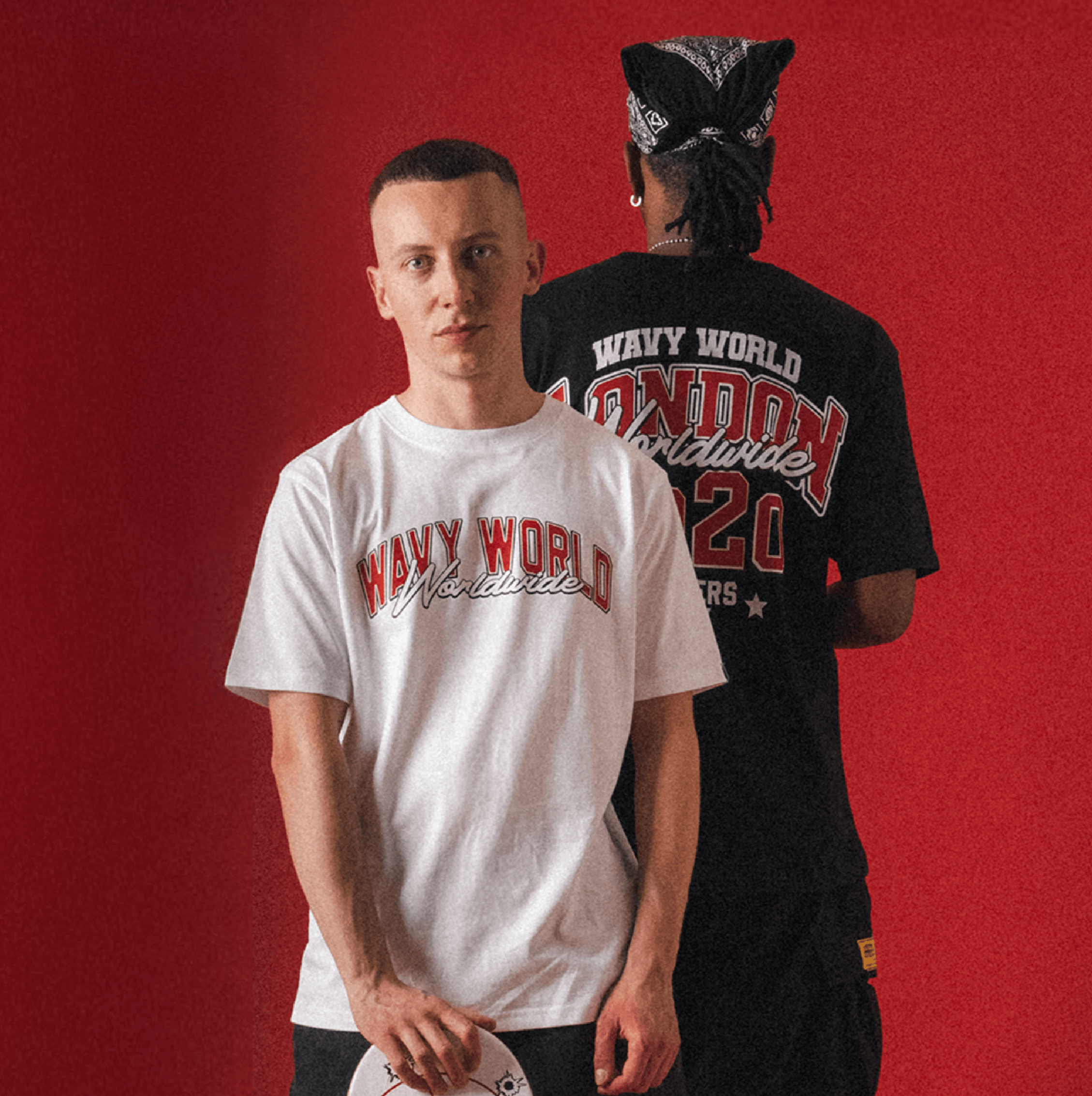 People wearing the black and white Wavy World Varsity Tee from Drop 1 - Hip Hop & Cereal, styled with casual streetwear pieces, standing against a Red background.